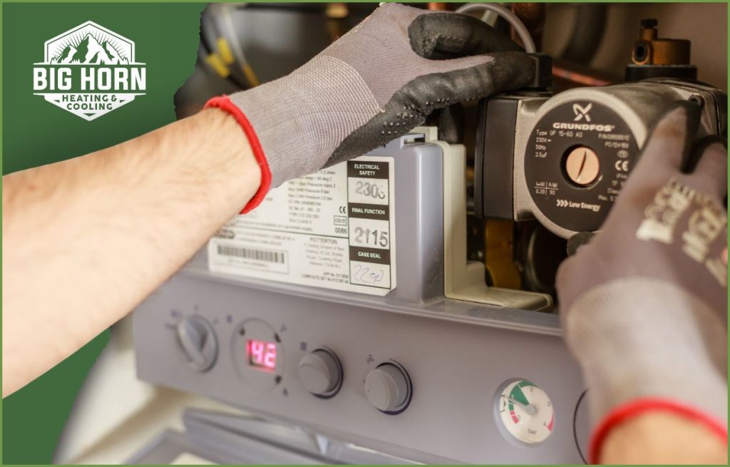 An HVAC technician servicing a boiler.